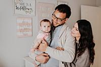 Couple with baby daughter in baby's room
