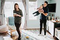 Mid adult couple playing with baby son in living r