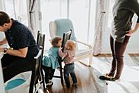 Baby boy and toddler sister playing in living room