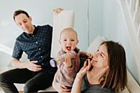 Mid adult couple on sofa with baby son