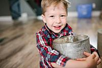 Toddler carrying plant pot