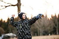 Boy preparing to throw baseball ball in rural fiel