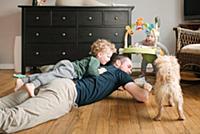 Father and son playing, pet dog joining in