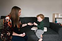 Mother and son on sofa