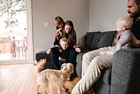 Family and sons with pet dog in living room