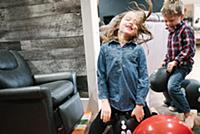 Children playing on inflatable toy at home