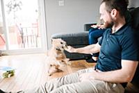 Man and pet dog in living room
