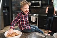 Toddler grabbing freshly baked vegetarian seed bal
