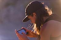 Woman operating drone (unmanned aerial vehicle) us