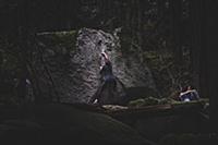 Climber bouldering, watched by friend, Squamish, C