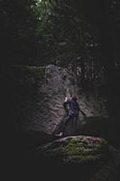 Climber bouldering in forest, Squamish, Canada