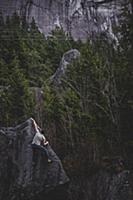 Climber bouldering in forest, Squamish, Canada