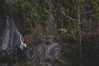 Climber bouldering in forest, Squamish, Canada
