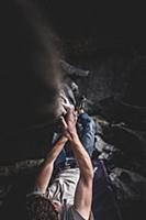 Climber bouldering in forest, Squamish, Canada