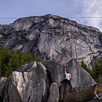 Climber bouldering in forest, Squamish, Canada