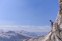 Climber trad climbing, Tuolumne Meadows, Yosemite 