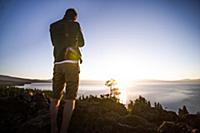 Man taking photographs at sunrise, Lake Tahoe, Tah