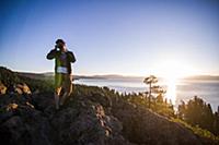 Man taking photographs at sunrise, Lake Tahoe, Tah