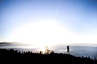 Man taking photographs at sunrise, Lake Tahoe, Tah