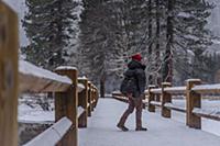 Climber on snow covered bridge, Yosemite National 