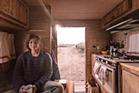 Woman relaxing inside campervan in desert, Sierra 