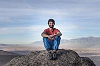 Climber enjoying view on mountain peak, Sierra Nev