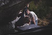 Climber bouldering, watched by friend, Squamish, C