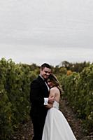 Romantic young bride and groom hugging in vineyard