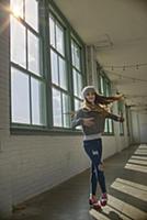 Teenage girl with long brown hair spinning in danc