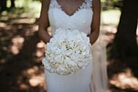 Young bride holding bouquet of white flowers in wo