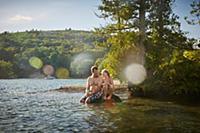 Father and daughter relaxing at lake