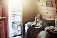 Woman drinking on sofa at home