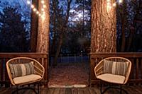 Two wicker chairs on verandah of house