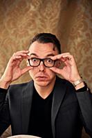 Comedian adjusting spectacles for clearer vision