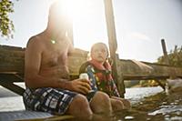 Father and daughter relaxing at lake