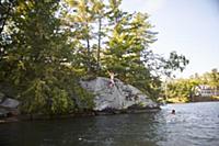 Father and daughter cliff jumping