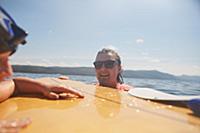 Couple paddle boarding in lake