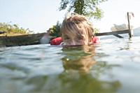 Girl swimming and playing in lake