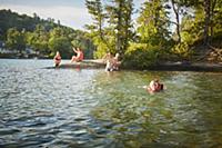 Family swimming in lake