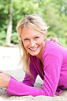 Portrait of pretty blonde woman wearing purple top