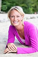 Portrait of pretty blonde woman wearing purple top