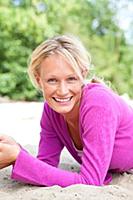 Portrait of pretty blonde woman wearing purple top