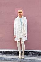 Contemplative blonde woman in white cashmere coat 