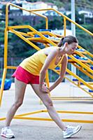 Woman wearing sportswear performing stretching exe