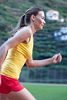 Side view of woman wearing sportswear running on t