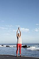 Brunette woman performing sukshma yoga exercise on