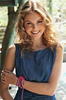 A young blonde woman outside wearing a blue summer