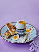 Boiled egg and buttered slices of toast