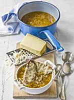 French onion soup in bowl and saucepan with baguet