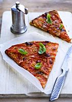 Two slices tomato tart with basil and pepper mill